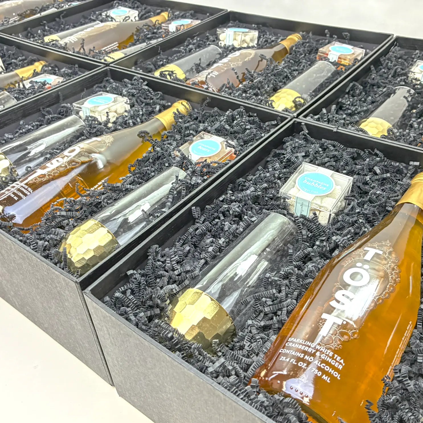 A line of corporate gifts with sparkling beverages and candies