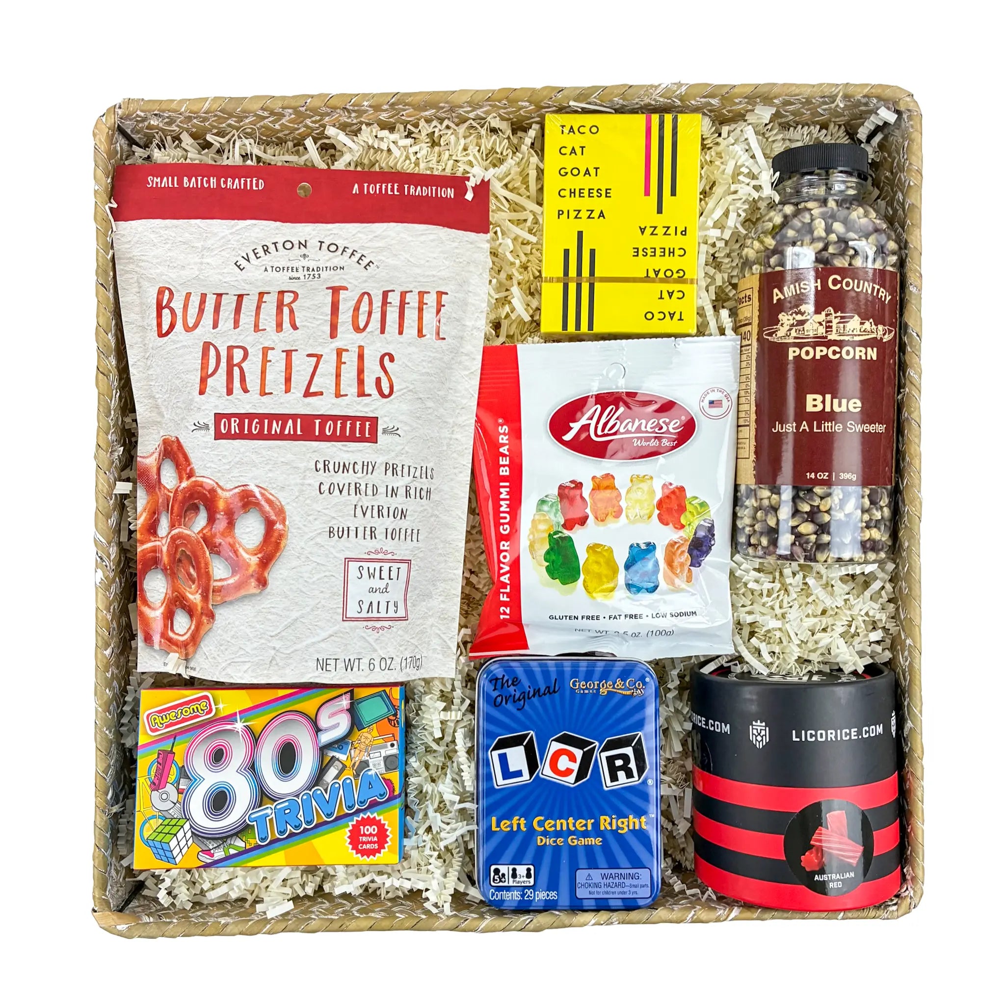 Gourmet gift basket with snacks and games including butter toffee pretzels and popcorn.
