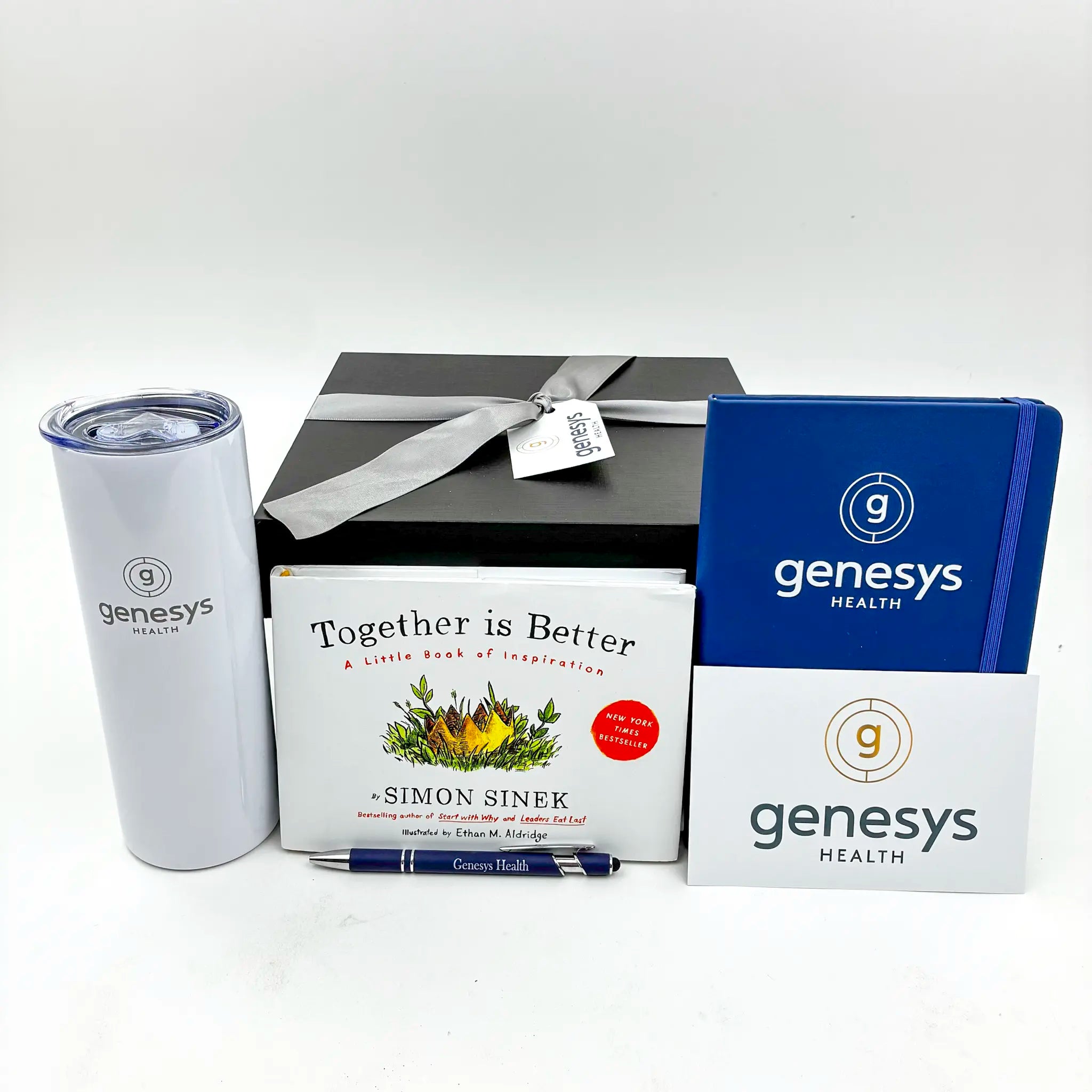 Gift set with Genesys Health branding including a tumbler, book, and notebook.