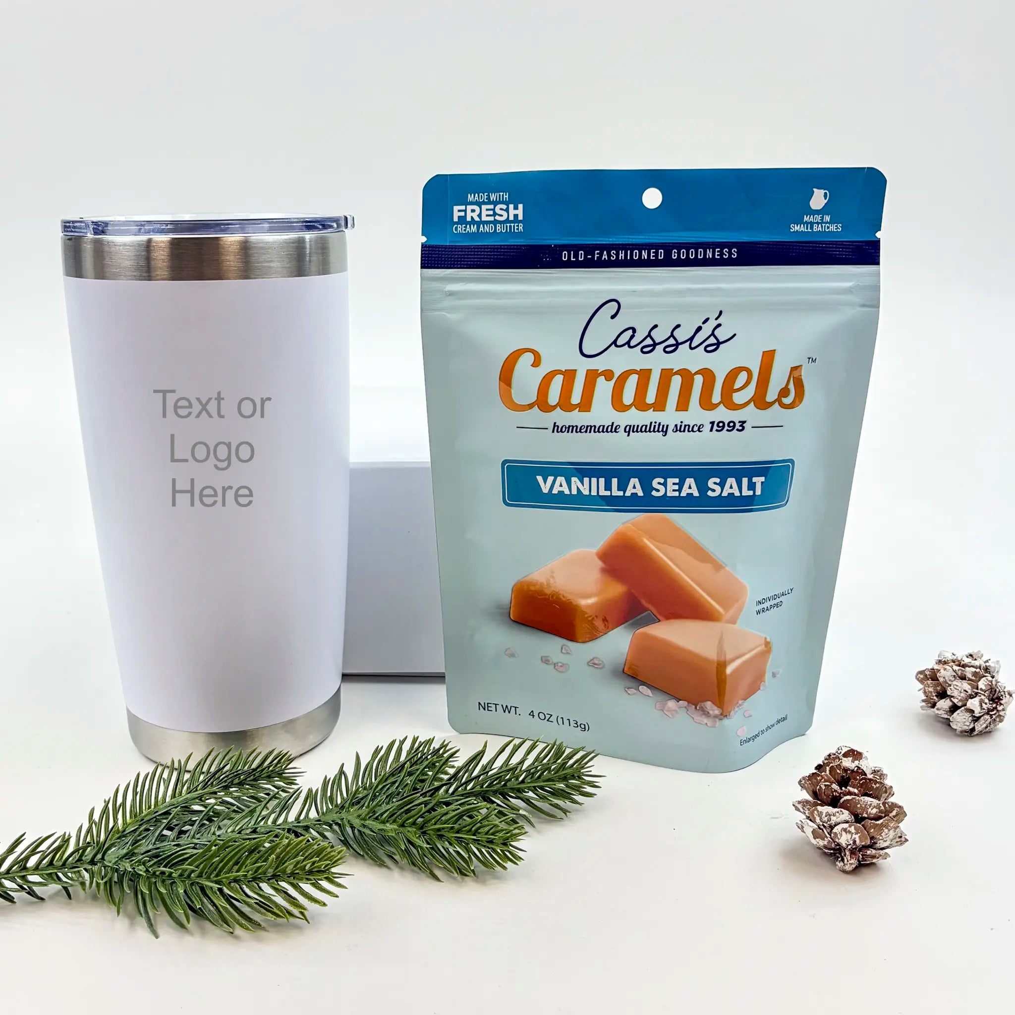 White tumbler with customizable text or logo, Cassi's Caramels Vanilla Sea Salt package, and decorative elements on a white background.