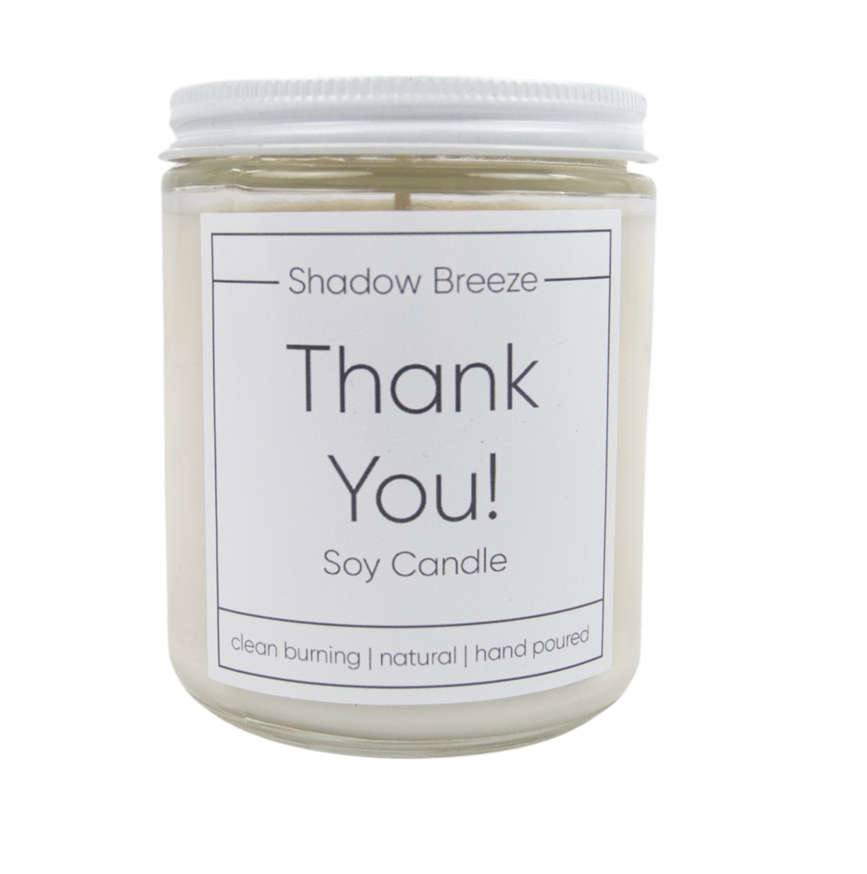 A white soy candle jar with a label that reads 'Shadow Breeze Thank You! Soy Candle', with a clear lid on top.