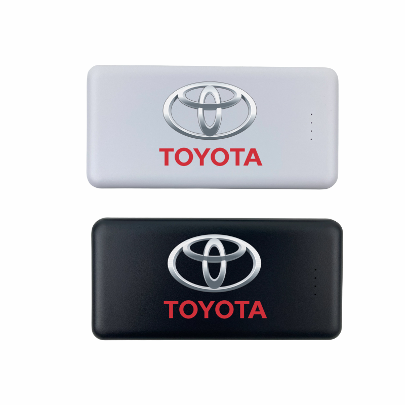 Two power banks, one white and one black, each featuring the Toyota logo and the word 'TOYOTA' in capital letters.