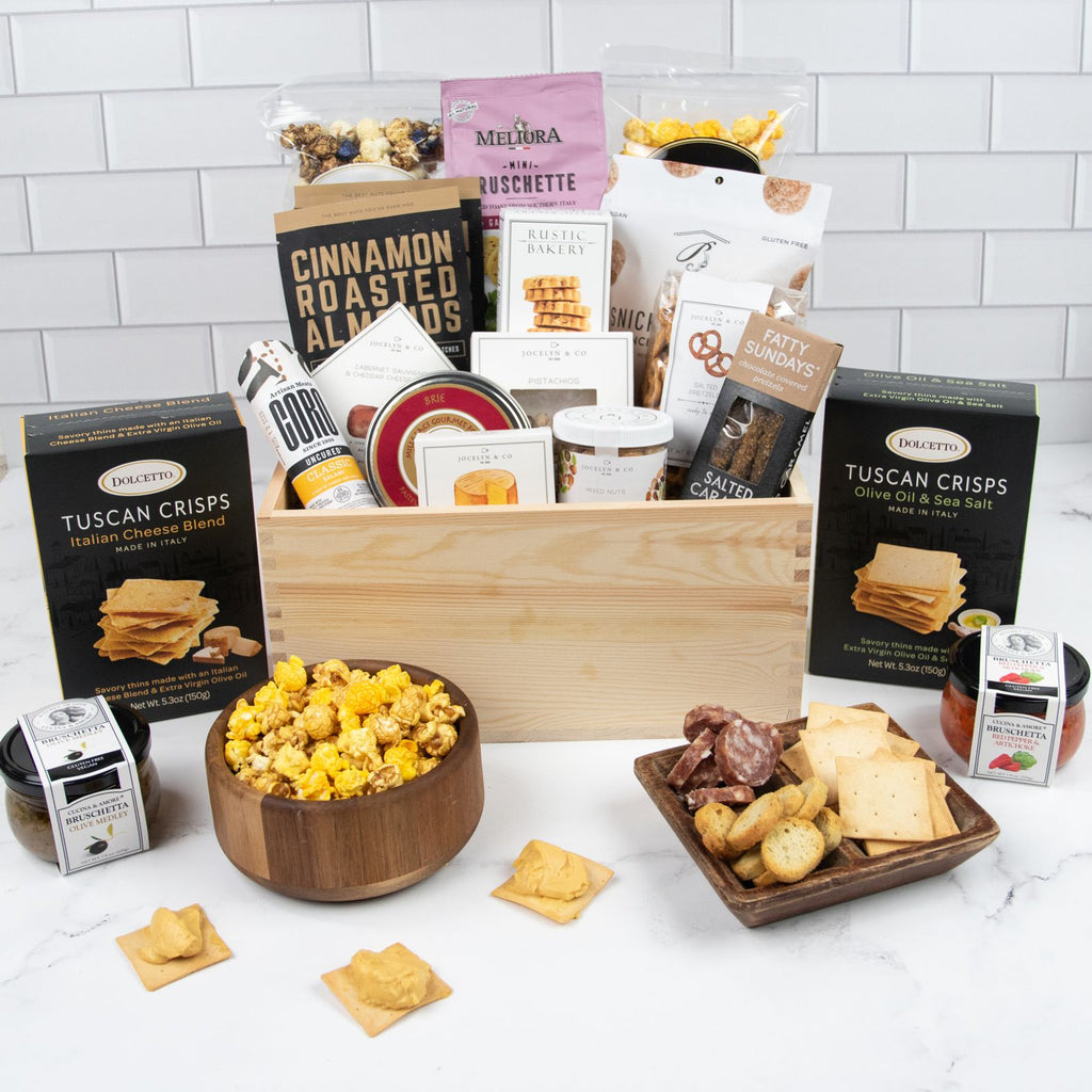 Assorted corporate food gifts in elegant packaging on table.