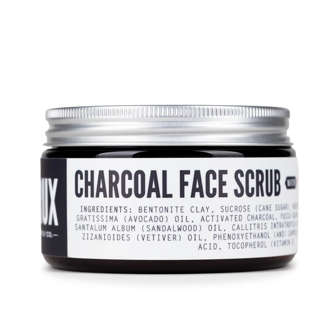 Jar of charcoal face scrub with a white label on a white background