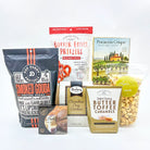 Assorted snack packages including smoked gouda pretzel sticks, butter toffee pretzels, and caramels on a white background