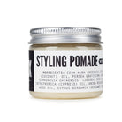 Jar of styling pomade with a white background