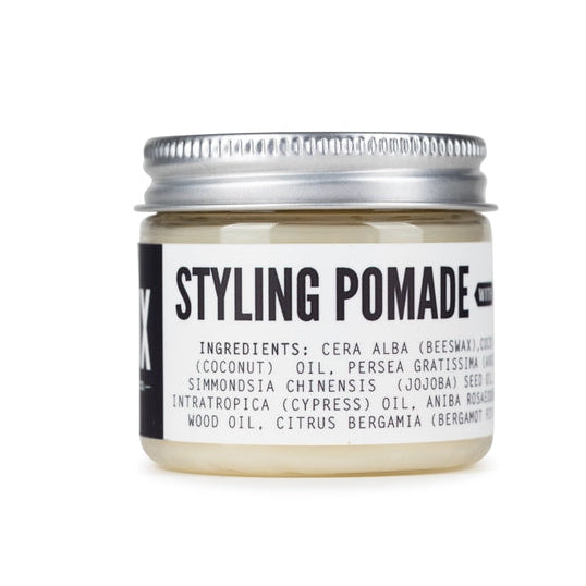 Jar of styling pomade with a white background