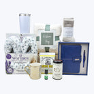 Collection of gift items including a mug, tumbler, and wellness products on a white background