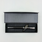 Silver pen in a black gift box on a light gray background