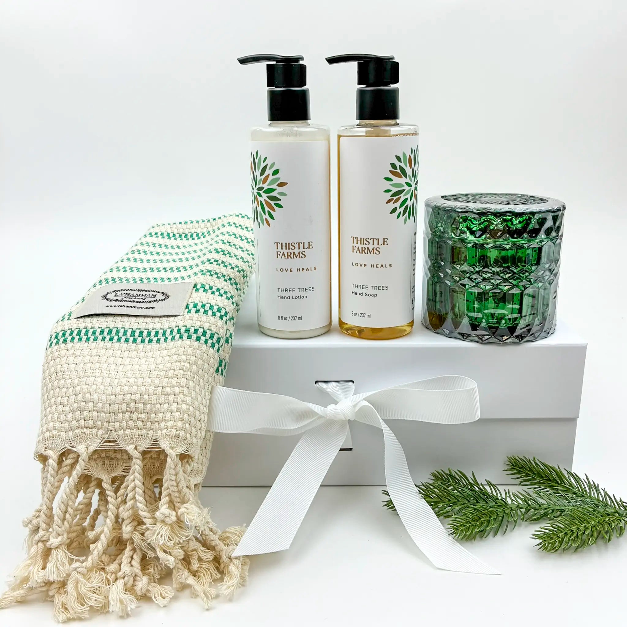 Bath and body set with 'Thistle Farms' products on a white background