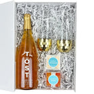 Gift set with a bottle of Töst sparkling wine, two gold flutes, and two boxes of candy in a white box.