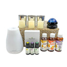 Essential oil diffuser, candles, and essential oil bottles on a white background