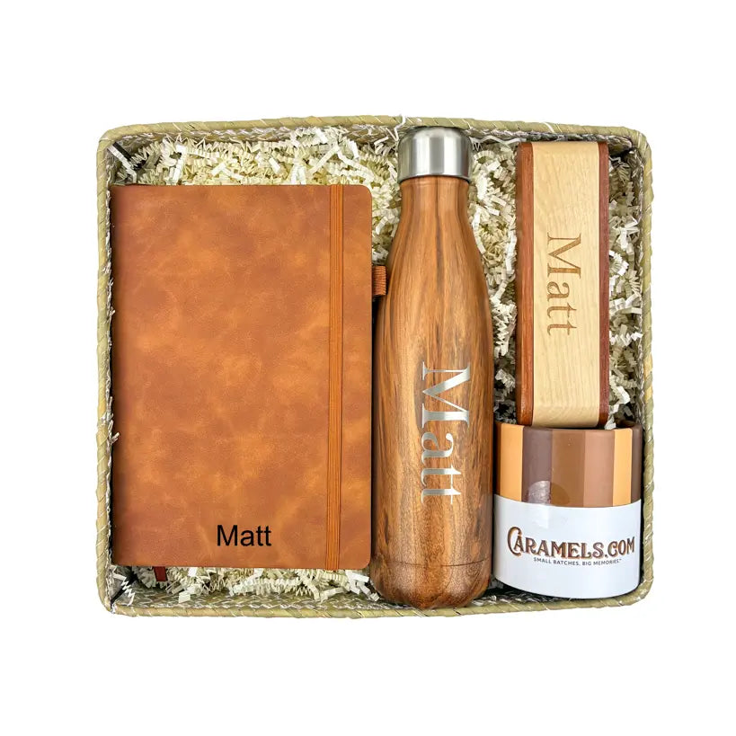 Gift set with brown leather notebook, wooden water bottle, and wooden item in a box.