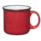 Red speckled mug with a black rim on a white background