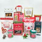 Assorted holiday-themed snacks and treats on a white background