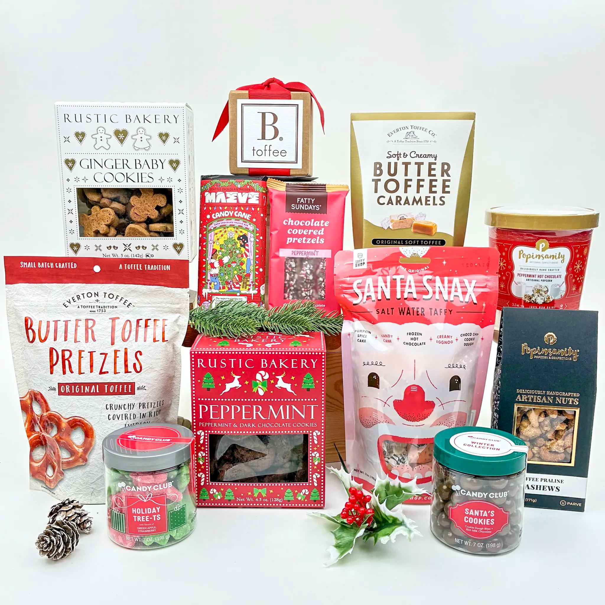 Assorted holiday-themed snacks and treats on a white background