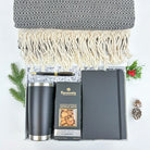 Gift set with a notebook, tumbler, and snacks on a white background