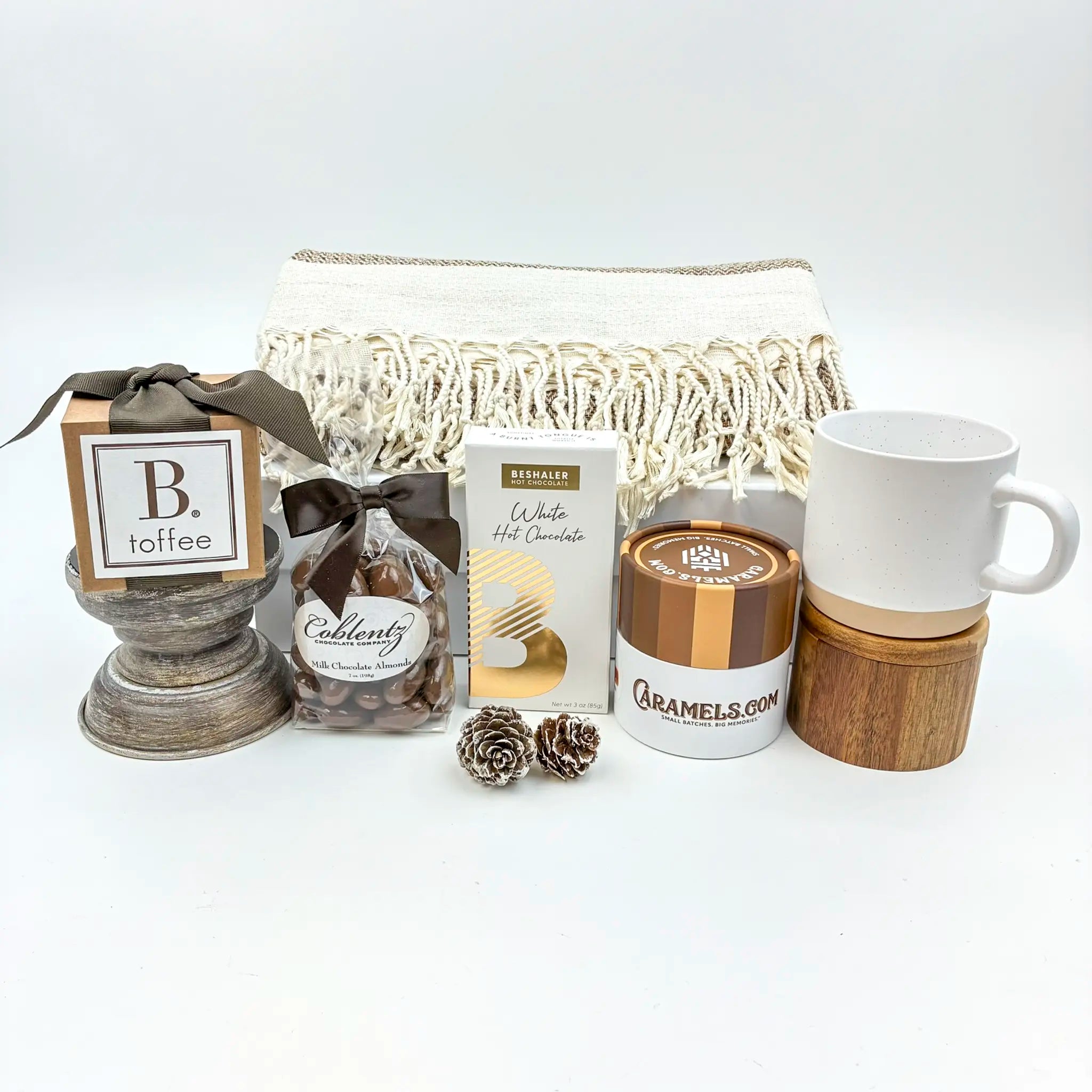Collection of gift items including a mug, cookies, and a box on a white background